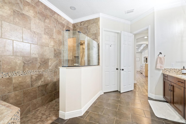 bathroom with vanity, crown molding, a walk in shower, and visible vents