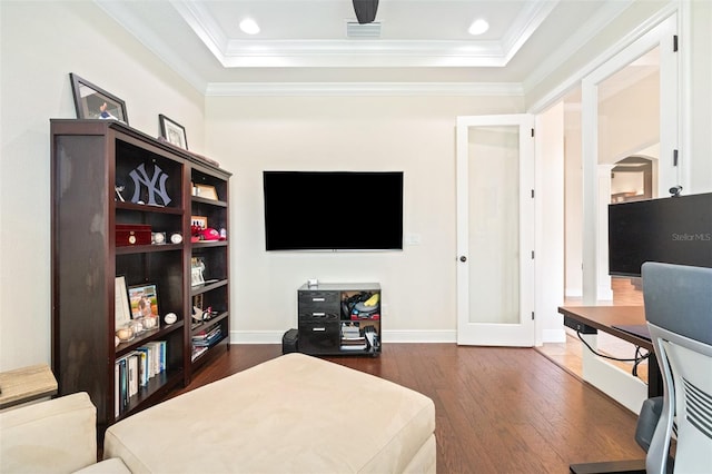 bedroom featuring visible vents, baseboards, dark wood finished floors, a tray ceiling, and crown molding