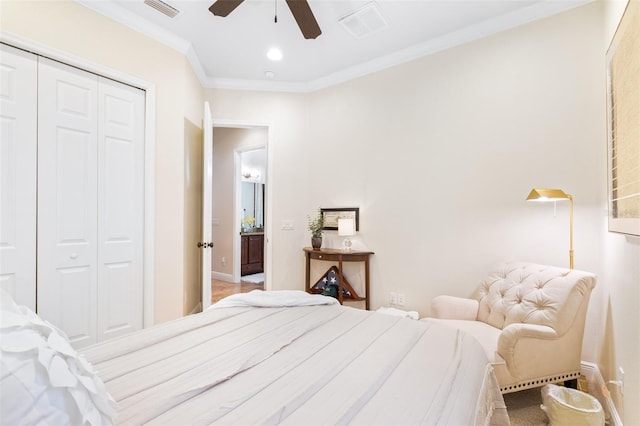 bedroom with a closet, visible vents, crown molding, and baseboards