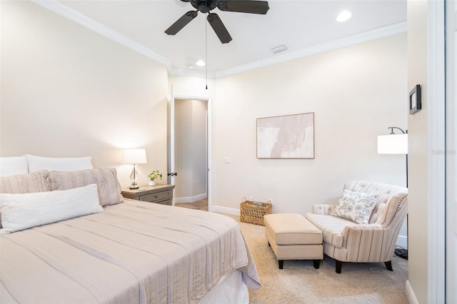 bedroom featuring baseboards, light carpet, and crown molding