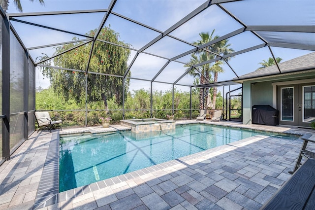 view of swimming pool with area for grilling, french doors, a pool with connected hot tub, and a patio