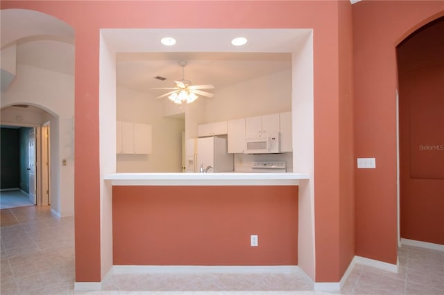 1020 New Winsor Loop Unit 46, Sun City Center, FL 33573 - kitchen featuring white appliances, ceiling fan, white cabinetry, a peninsula, and recessed lighting
