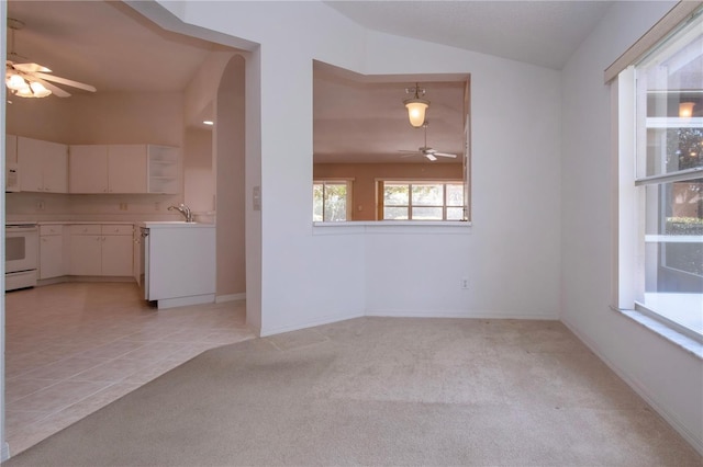 1020 New Winsor Loop Unit 46, Sun City Center, FL 33573 - spare room with ceiling fan, a sink, vaulted ceiling, light carpet, and baseboards