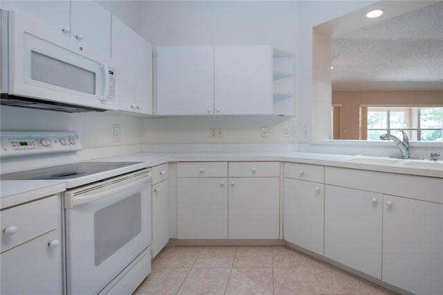 1020 New Winsor Loop Unit 46, Sun City Center, FL 33573 - kitchen with white appliances, a sink, open shelves, light countertops, and a textured ceiling
