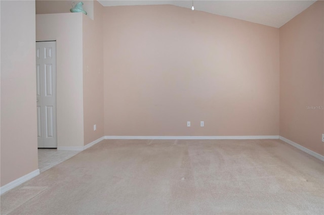 1020 New Winsor Loop Unit 46, Sun City Center, FL 33573 - empty room featuring light colored carpet, baseboards, and lofted ceiling
