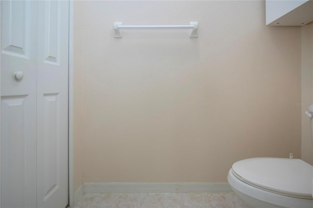 1020 New Winsor Loop Unit 46, Sun City Center, FL 33573 - bathroom with baseboards, a closet, toilet, and tile patterned floors