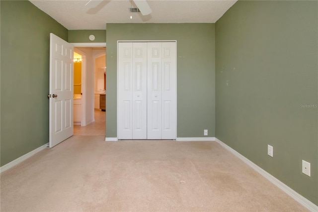 1020 New Winsor Loop Unit 46, Sun City Center, FL 33573 - unfurnished bedroom featuring light colored carpet, baseboards, a closet, and ceiling fan