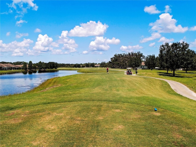 1020 New Winsor Loop Unit 46, Sun City Center, FL 33573 - view of property's community with a water view, golf course view, a lawn, and curved driveway