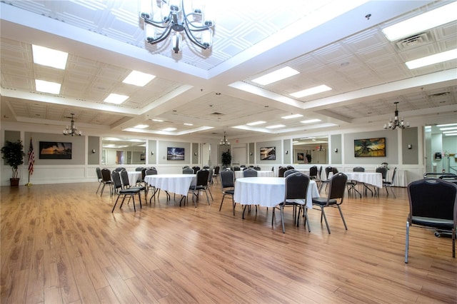 1020 New Winsor Loop Unit 46, Sun City Center, FL 33573 - dining area featuring a chandelier, light wood finished floors, beamed ceiling, and coffered ceiling