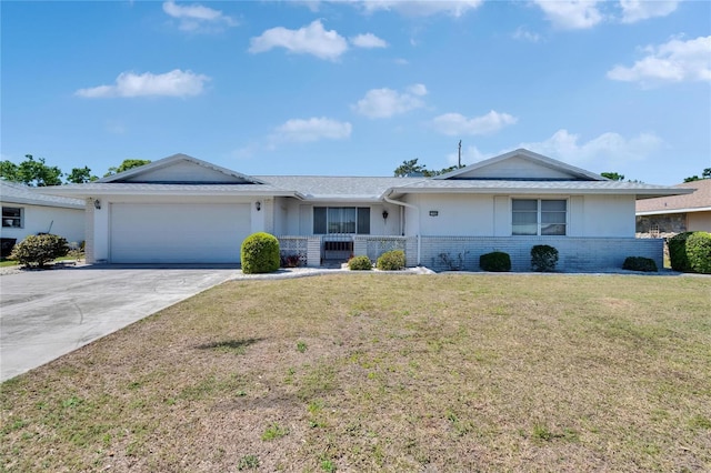 ranch-style home featuring an attached garage, brick siding, a front yard, and driveway