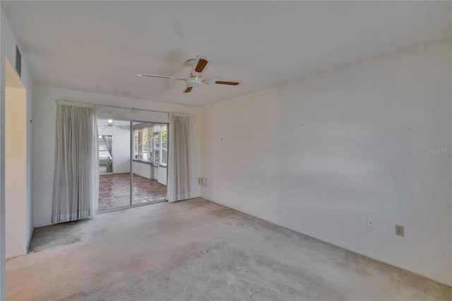 spare room with concrete flooring, visible vents, and ceiling fan