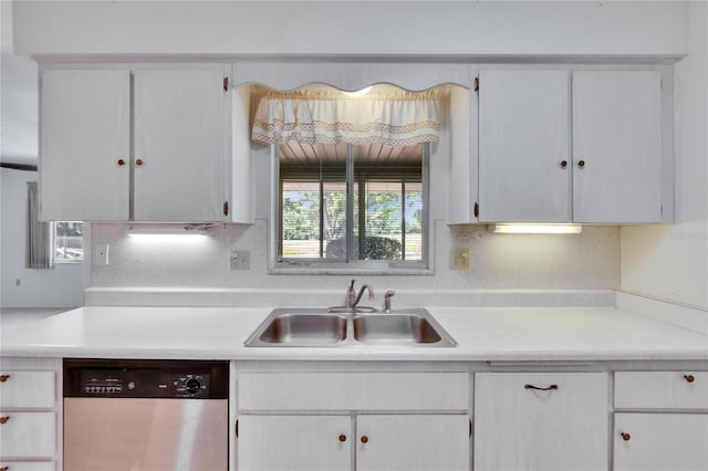 kitchen featuring white cabinetry, light countertops, a sink, and stainless steel dishwasher