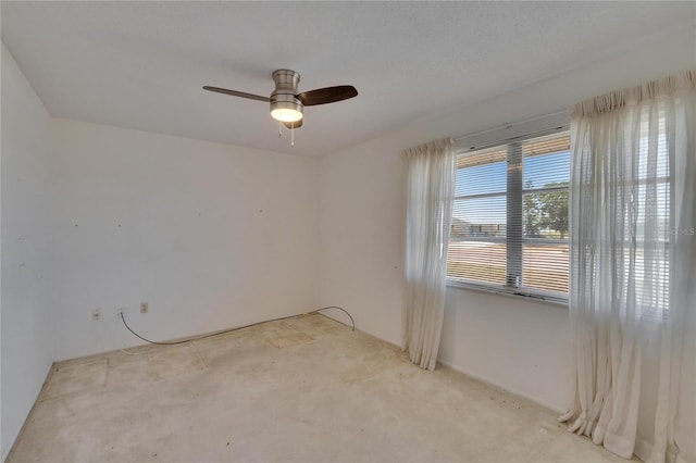 unfurnished room featuring a ceiling fan and light colored carpet