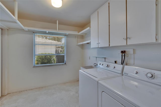 laundry area featuring cabinet space, a sink, and washer and dryer