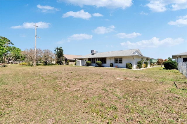 back of property featuring a yard