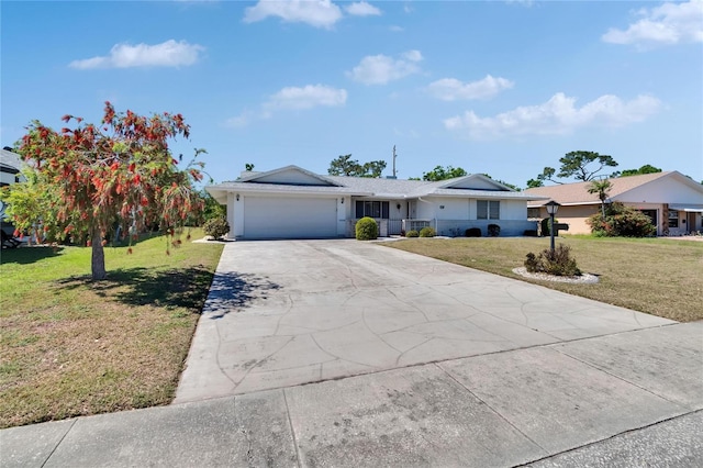 single story home featuring driveway, a front yard, a garage, and stucco siding