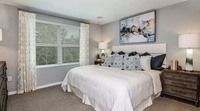 carpeted bedroom featuring baseboards