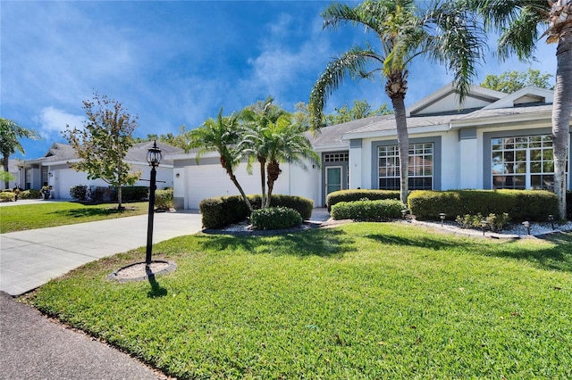 single story home with concrete driveway, an attached garage, a front lawn, and stucco siding