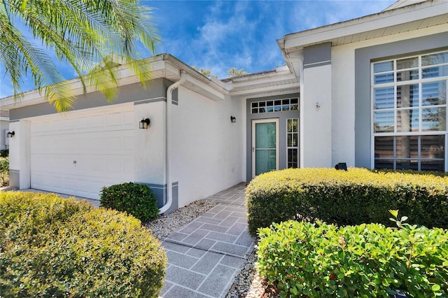 1034 Mcdaniel St Unit 1034, Sun City Center, FL 33573 - doorway to property featuring stucco siding and a garage