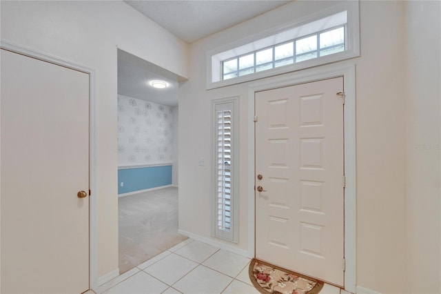 1034 Mcdaniel St Unit 1034, Sun City Center, FL 33573 - entrance foyer with light tile patterned floors, baseboards, light carpet, and wallpapered walls