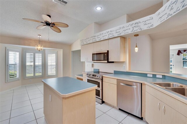 1034 Mcdaniel St Unit 1034, Sun City Center, FL 33573 - kitchen featuring visible vents, light brown cabinets, decorative light fixtures, appliances with stainless steel finishes, and light tile patterned floors