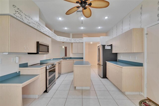 1034 Mcdaniel St Unit 1034, Sun City Center, FL 33573 - kitchen featuring light tile patterned floors, a ceiling fan, a sink, light brown cabinetry, and appliances with stainless steel finishes
