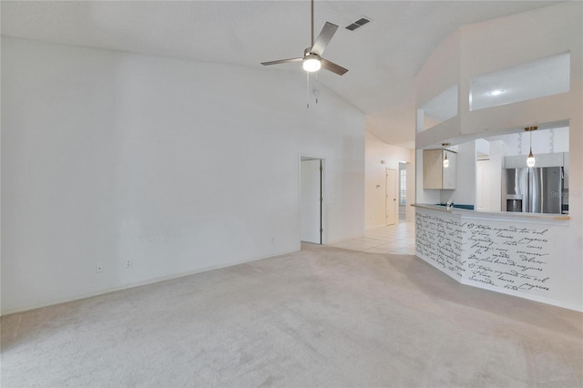 1034 Mcdaniel St Unit 1034, Sun City Center, FL 33573 - unfurnished living room featuring visible vents, high vaulted ceiling, light tile patterned flooring, light colored carpet, and ceiling fan