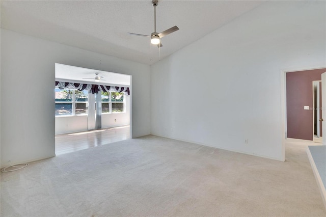 1034 Mcdaniel St Unit 1034, Sun City Center, FL 33573 - spare room with light carpet, high vaulted ceiling, and a ceiling fan