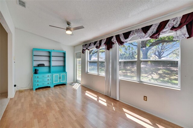 1034 Mcdaniel St Unit 1034, Sun City Center, FL 33573 - interior space featuring visible vents, a textured ceiling, wood finished floors, and a ceiling fan