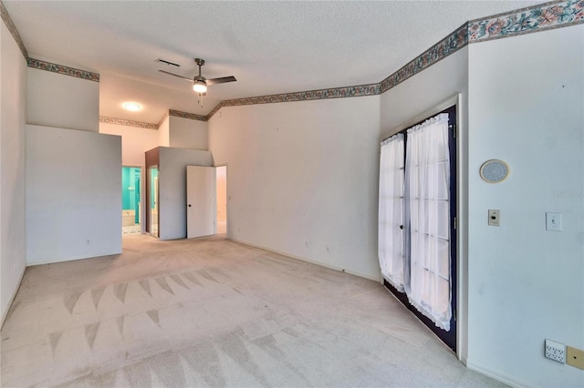 1034 Mcdaniel St Unit 1034, Sun City Center, FL 33573 - carpeted empty room featuring a textured ceiling, lofted ceiling, visible vents, and ceiling fan