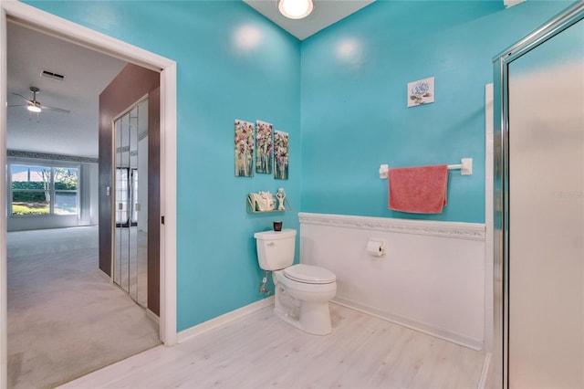 1034 Mcdaniel St Unit 1034, Sun City Center, FL 33573 - bathroom featuring visible vents, toilet, wood finished floors, baseboards, and ceiling fan