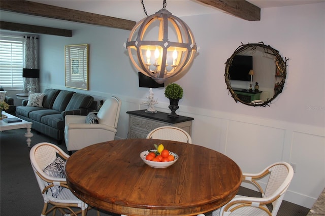 979 E Gulf Dr Unit D402, Sanibel, FL 33957 - carpeted dining area featuring a wainscoted wall, an inviting chandelier, a decorative wall, and beamed ceiling