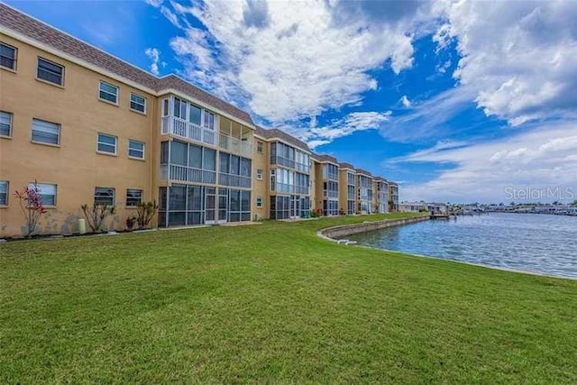 view of property's community featuring a yard and a water view