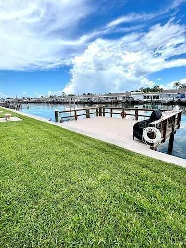 dock area with a lawn and a water view