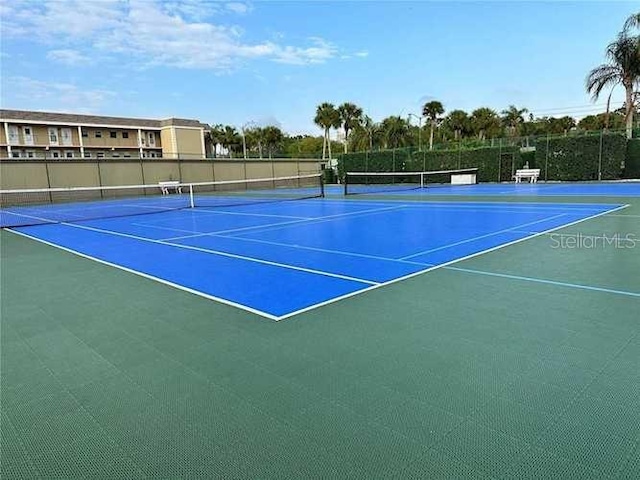 view of tennis court with fence