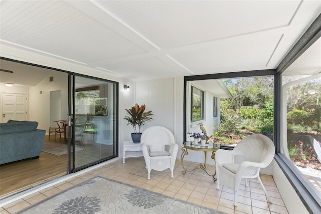 sunroom featuring beam ceiling