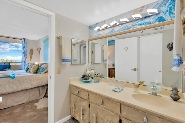 bathroom featuring visible vents, ensuite bath, tile patterned flooring, baseboards, and vanity