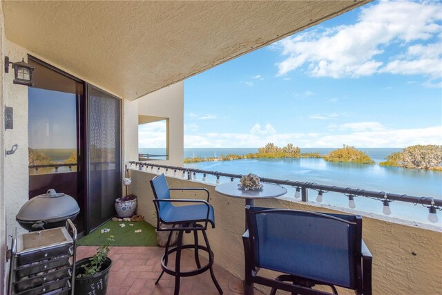 balcony featuring a water view