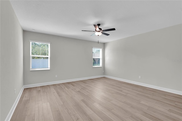 17526 SW 25th Cir, Ocala, FL 34473 - empty room with plenty of natural light, light wood-style flooring, and a ceiling fan