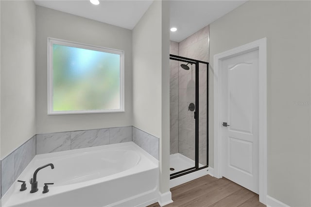 17526 SW 25th Cir, Ocala, FL 34473 - full bath featuring a garden tub, a shower stall, wood finished floors, and recessed lighting
