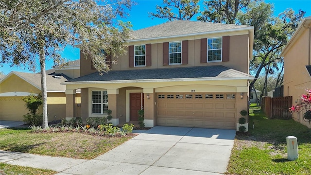 traditional home featuring stucco siding, a garage, roof with shingles, and concrete driveway