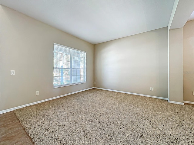 unfurnished room featuring baseboards