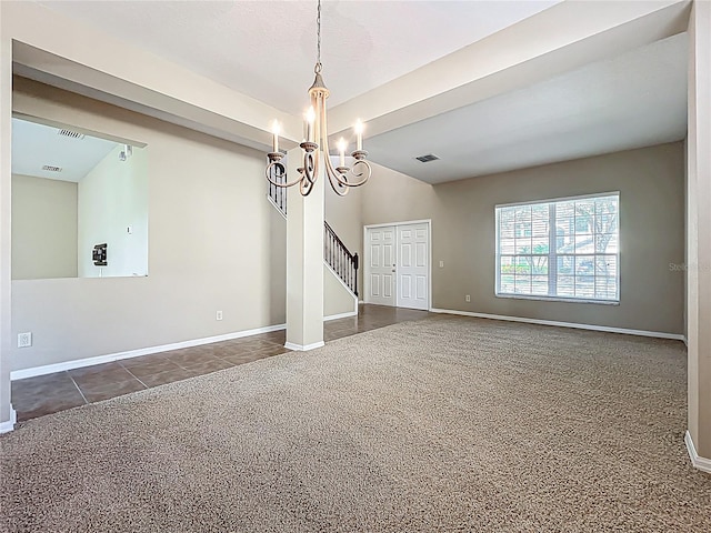 unfurnished dining area featuring tile patterned floors, visible vents, a notable chandelier, carpet, and baseboards