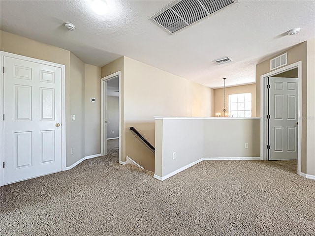 empty room featuring visible vents and carpet floors