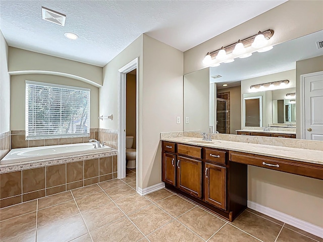 full bathroom with tile patterned floors, visible vents, toilet, a stall shower, and a textured ceiling