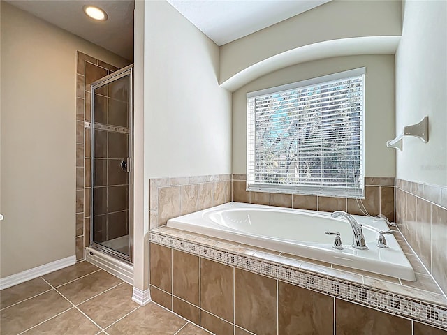 full bath with tile patterned flooring, a shower stall, baseboards, and a garden tub