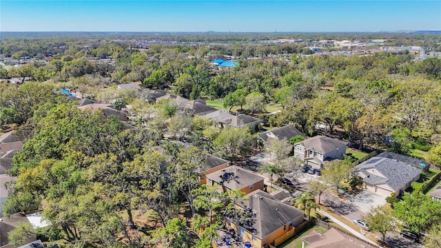 aerial view featuring a wooded view and a residential view