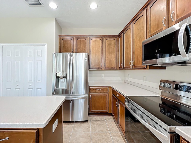 kitchen featuring visible vents, recessed lighting, appliances with stainless steel finishes, light tile patterned flooring, and light countertops