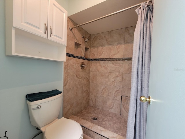 full bath with toilet and a tile shower