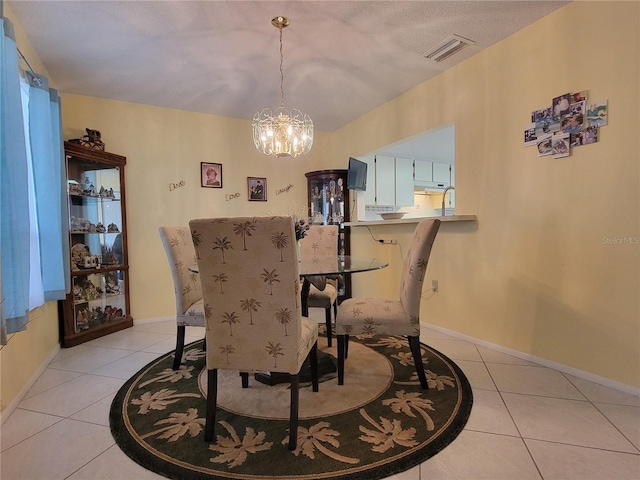 dining area with visible vents, baseboards, a notable chandelier, and light tile patterned flooring